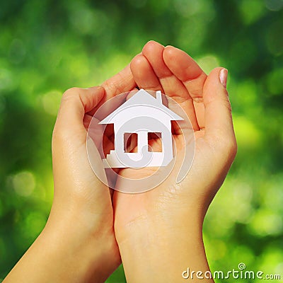 Paper Family and Heart in Hands over Green Sunny Background Stock Photo