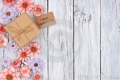 Paper flowers side border with Mother`s Day gift and tag over wood Stock Photo