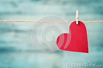 Paper heart hanging on string against turquoise wooden background for Valentines day Stock Photo