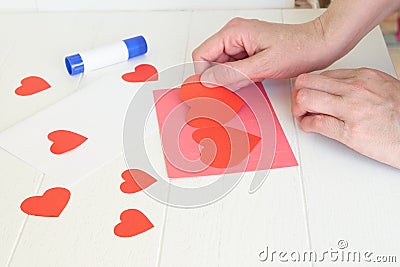 Paper hearts over the background with paper cut shapes. Saint Valentine, mother& x27;s day, birthday greeting cards Stock Photo
