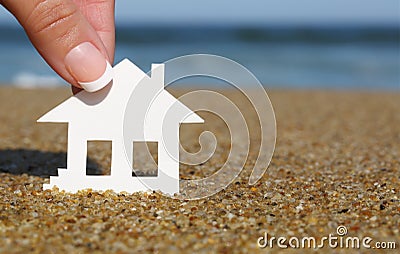 Paper house on the beach. Concept of mortgage Stock Photo