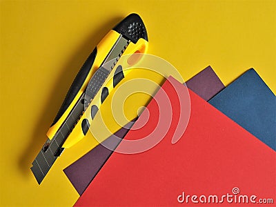 Paper knife and colored sheets of paper Stock Photo