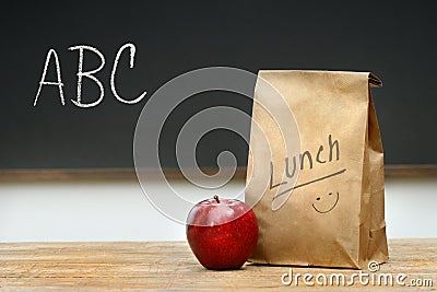 Paper lunch bag on desk Stock Photo