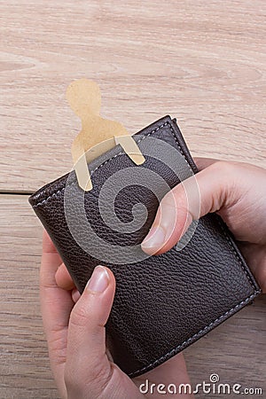 Paper man shape in wallet in hand Stock Photo