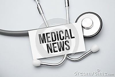 Paper with medical news on a table and grey stethoscope Stock Photo