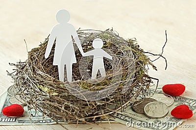 Paper mother and son in nest on money and hearts - Concept of single parent family Stock Photo