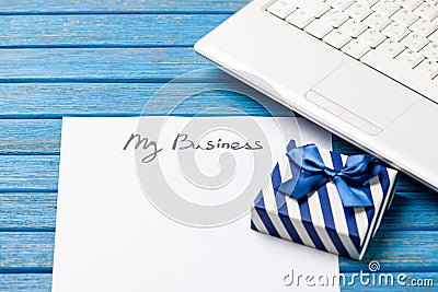 Paper with My Business inscription near notebook Stock Photo