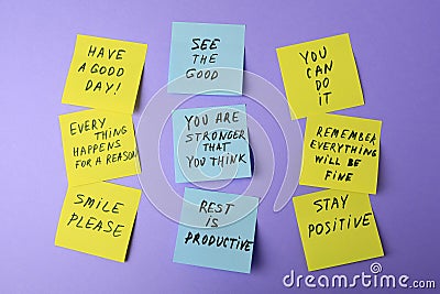 Paper notes with life-affirming phrases on violet background Stock Photo