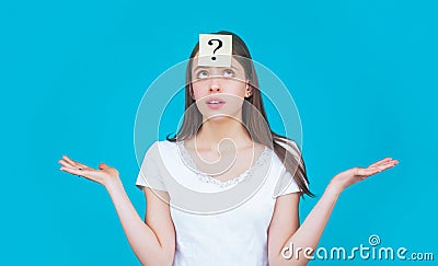 Paper notes with question marks. Confused female thinking with question mark on sticky note on forehead. Thinking woman Stock Photo