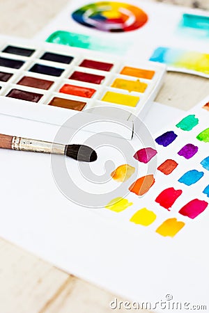 Paper, paint, brushes, color wheel Stock Photo