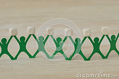 Paper people chain holding blank wooden cubes Stock Photo