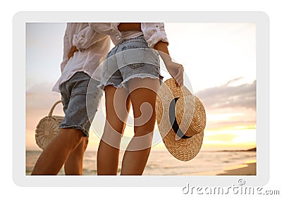 Paper photo. Lovely couple walking on beach at sunset, closeup Stock Photo