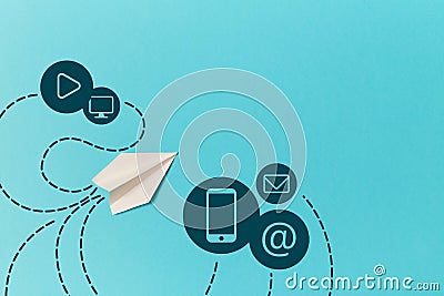 Paper plane and smartphone, email, monitor, play signs isolated on blue. E-mail marketing and delivery. SMM promotion Stock Photo