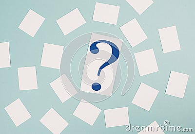 Paper with a question mark in the middle, small empty stickers around, copy space, brainstorming for new strategies, searching Stock Photo