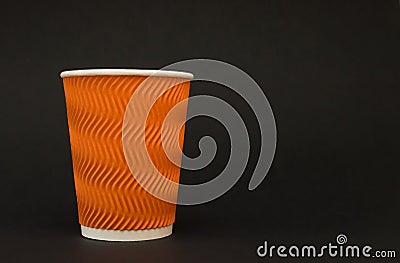 Paper reflow orange coffee cup stands on a black background Stock Photo