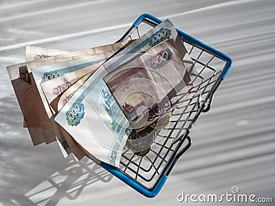 Money and shopping basket isolated on a white background Stock Photo
