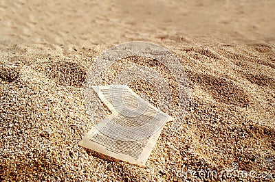 Paper sheets on golden sands Stock Photo