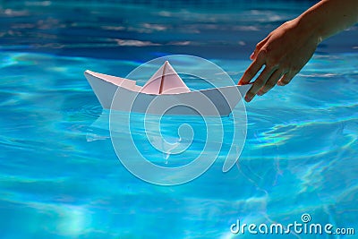 Paper ship in hand. Tourism and traveling, travel dreams vacation holiday, sailing adventure. Hand and paper boat. Stock Photo