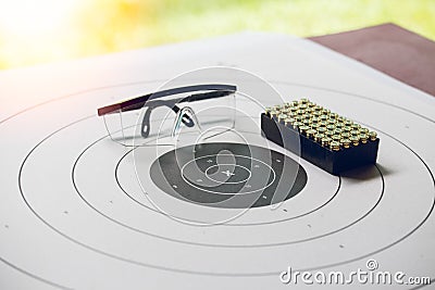 Paper shooting target with bullet and protection glassess Stock Photo