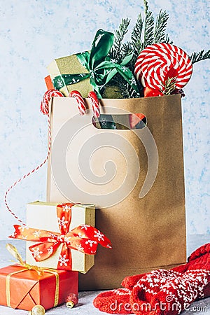 Paper shopping bag full of gift boxes Christmas ornamented Stock Photo