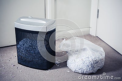 Paper shredder and bag of shredded documents Stock Photo