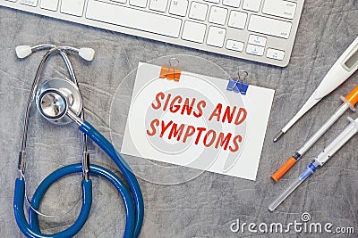 Paper with SIGNS AND SIMPTOMS on a table, stethoscope and pills Stock Photo