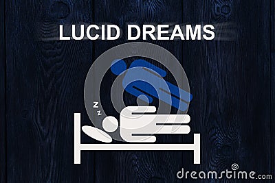 Paper sleeping man on bed with text LUCID DREAMS Stock Photo