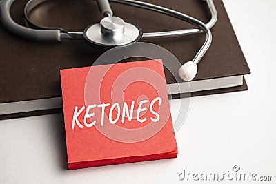 Paper with text ketones on blue background with stethoscope and pills Stock Photo