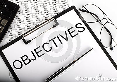 Paper with text OBJECTIVES on table on chart Stock Photo