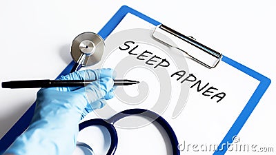 Paper with text SLEEP APNEA on a table with stethoscope Stock Photo