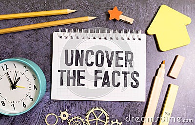 paper with text uncover the facts on white background Stock Photo