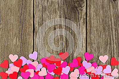 Paper Valentines Day heart bottom border on rustic wood Stock Photo