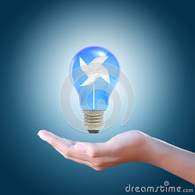 Paper windmill in a blue light bulb Stock Photo