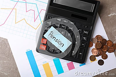 Paper with word PENSION, charts, coins and calculator on table Stock Photo