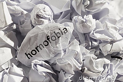 Paper written homofobia, portuguese and spanish word for homophobia. Concept of old and abandoned idea or practice. Stock Photo