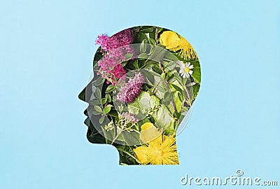 Papercut head with green leaves and flowers. Mental health, emotional wellness, contented emotions, self care, psychology, green Stock Photo