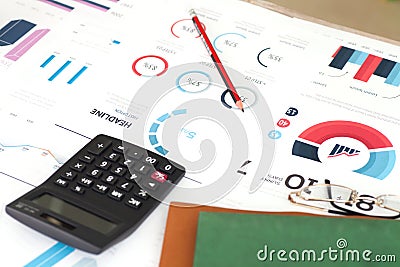 Papers and calculators and other items on the indoor desk Stock Photo