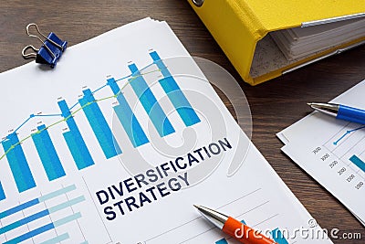 Papers with diversification strategy and charts about investments. Stock Photo