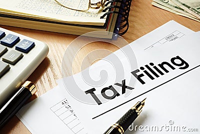 Papers with title Tax filing on an office desk. Stock Photo