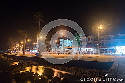 Night view on embankment and tourist walking alley along Mediterranean sea Editorial Stock Photo