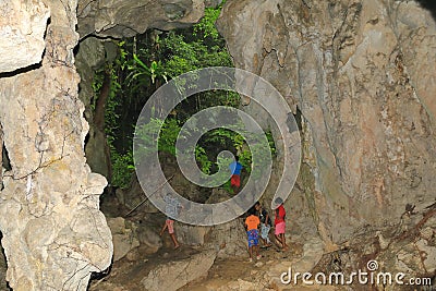 Papuan kids exploring lime stone cave Goa Jepang on Biak Island Editorial Stock Photo