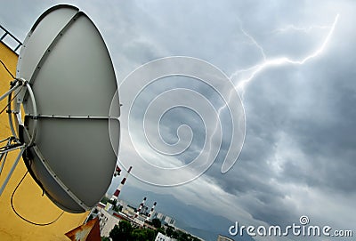 Parabolic antenna and lightning Stock Photo