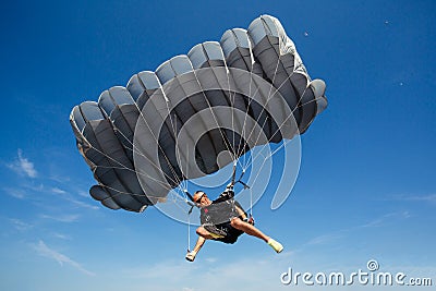 Parachute in the sky. Skydiver is flying a parachute in the blue sky. Stock Photo