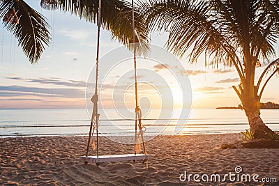 Paradise beach relaxing landscape, tropical swing at sunset Stock Photo