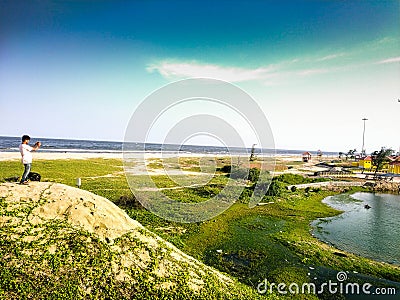 Paradise beach and Sand beach. A tourist is taking pictures of the beauty of the Sand beach located at Pondycherry/puducherry Ind Editorial Stock Photo