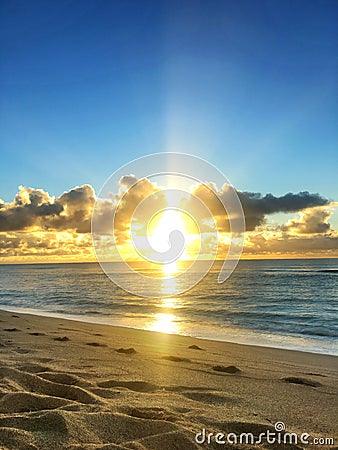 Paradise Glorious golden sunrise over the beach in Kauai Hawaii Stock Photo