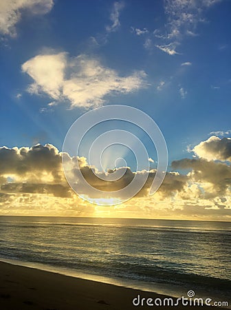 Paradise Glorious golden sunrise over the beach in Kauai Hawaii Stock Photo