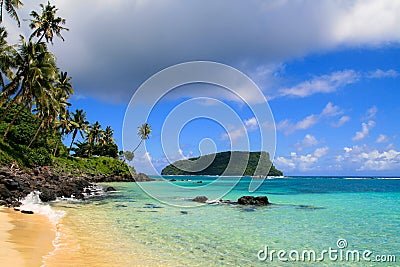 Paradise island tropical beach in Pacific Ocean with turquoise water, golden sand and exotic palm trees Stock Photo