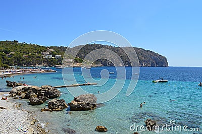 Panoramic seascape : beach, boats, mountains, rocks, cliffs, sea and sky. Mallorca, Spain Stock Photo