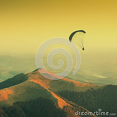 Paraglide silhouette in a Carpathian mountains. Vintage Stock Photo